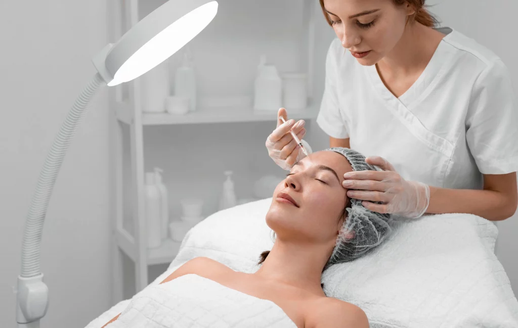 Beautician performing dermal filler injection on woman face for facial rejuvenation